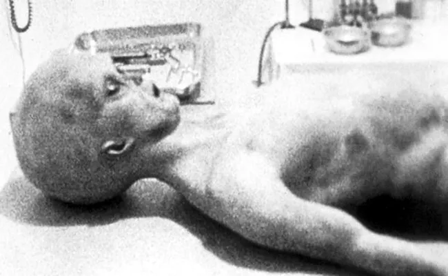 Alien carried away on a stretcher after Roswell spaceship crash'