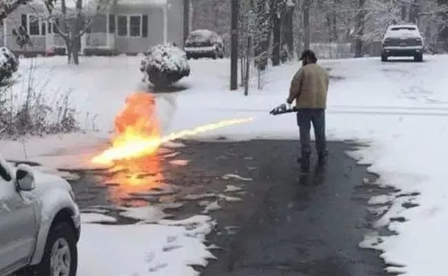  man uses a flamethrower to clear snow In USA - Sakshi
