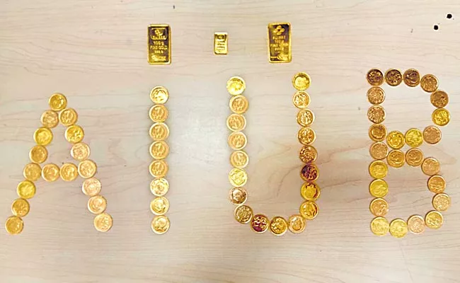 Shamshabad Airport Police Found Gold Biscuits And Chocolates - Sakshi