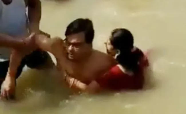Kissing His Wife Ayodhya Sarayu River Man Beaten Video Viral  - Sakshi