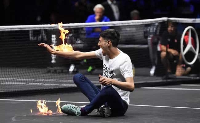 Man Sets Arm-On-Fire Dramatic Protest Before Roger Federer Last Match - Sakshi
