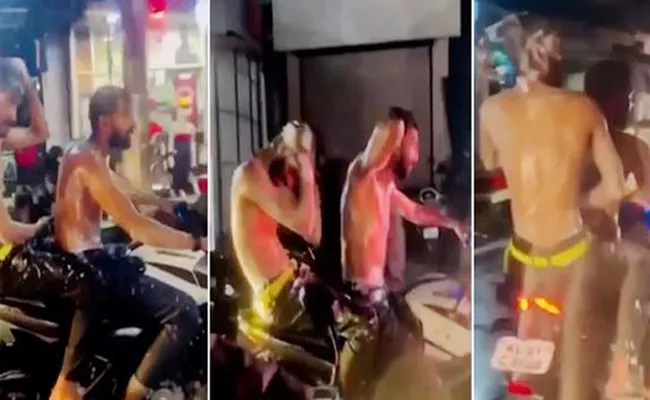 Kerala Youngsters Take Bath While Bike Riding Police Case Filed - Sakshi