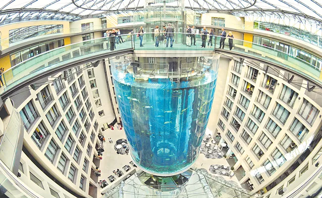 Aquarium in lobby of Berlin Radisson Blu hotel building bursts - Sakshi