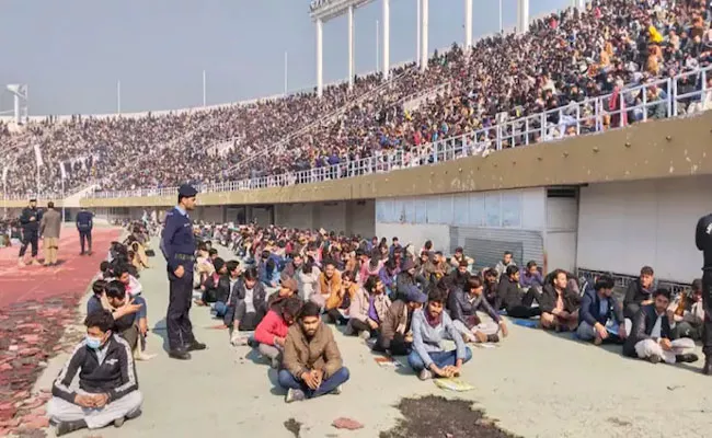 Youth In Pakistan Appear For Police Constable Exam Sit On Stadium - Sakshi