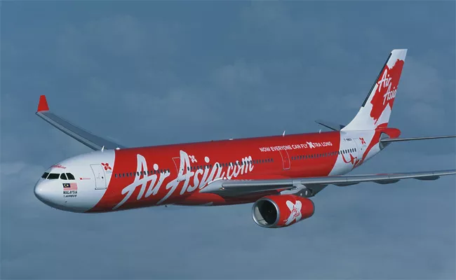 20 Lakh Rupees Penalty For Air Asia - Sakshi