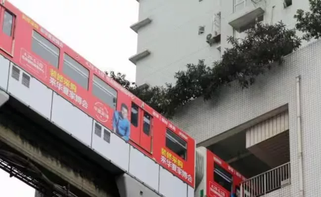 china train runs through residential building - Sakshi