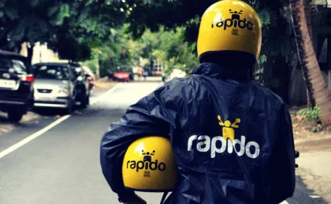 rapido driver arrives on a royal enfield in bengaluru - Sakshi