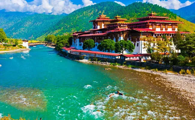 Bhutan cuts daily tourist fee by half to attract more visitors - Sakshi