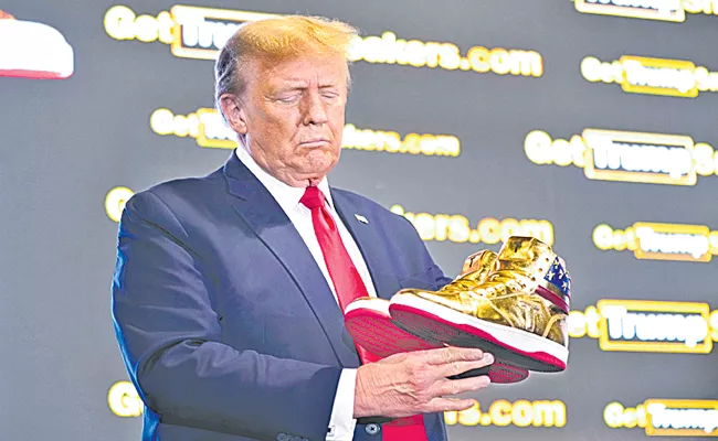 Donald Trump unveiled his line of gold sneakers at Sneaker Con in Philadelphia - Sakshi