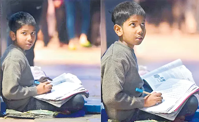 Boy studies on Delhi footpath, works to support family - Sakshi