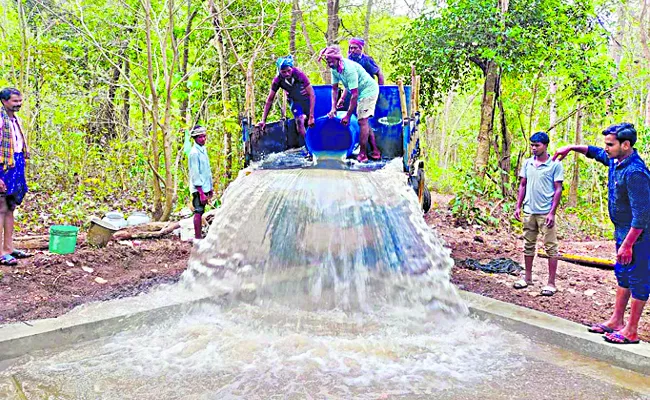 AP forest officials fill water bodies to quench animals thirst - Sakshi