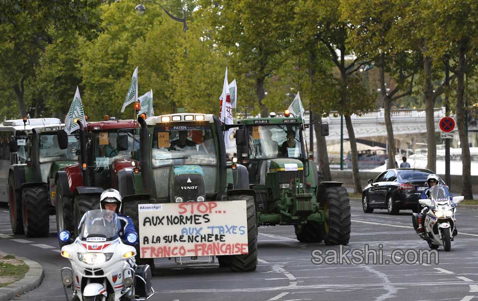 Tractors roll along a street in Paris6