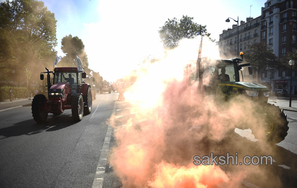 Tractors roll along a street in Paris16