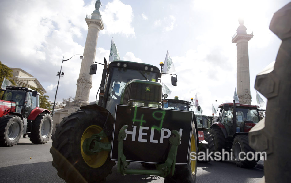 Tractors roll along a street in Paris14