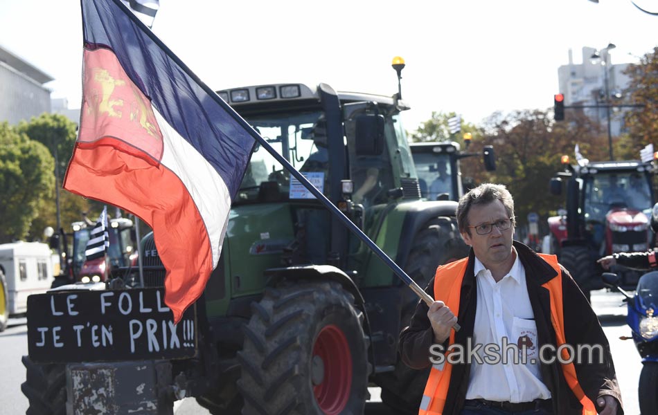 Tractors roll along a street in Paris17