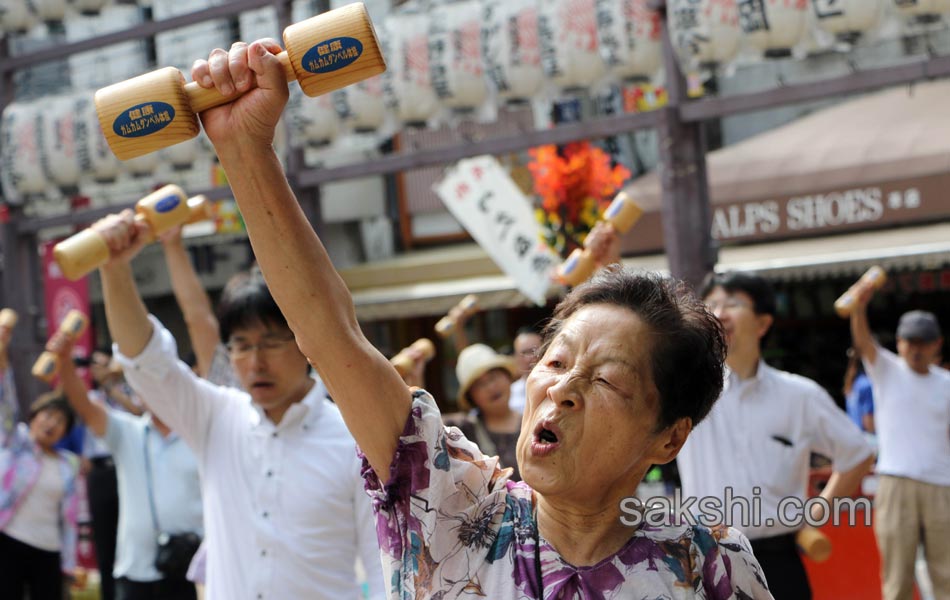 Elderly people work out with wooden dumb bells2