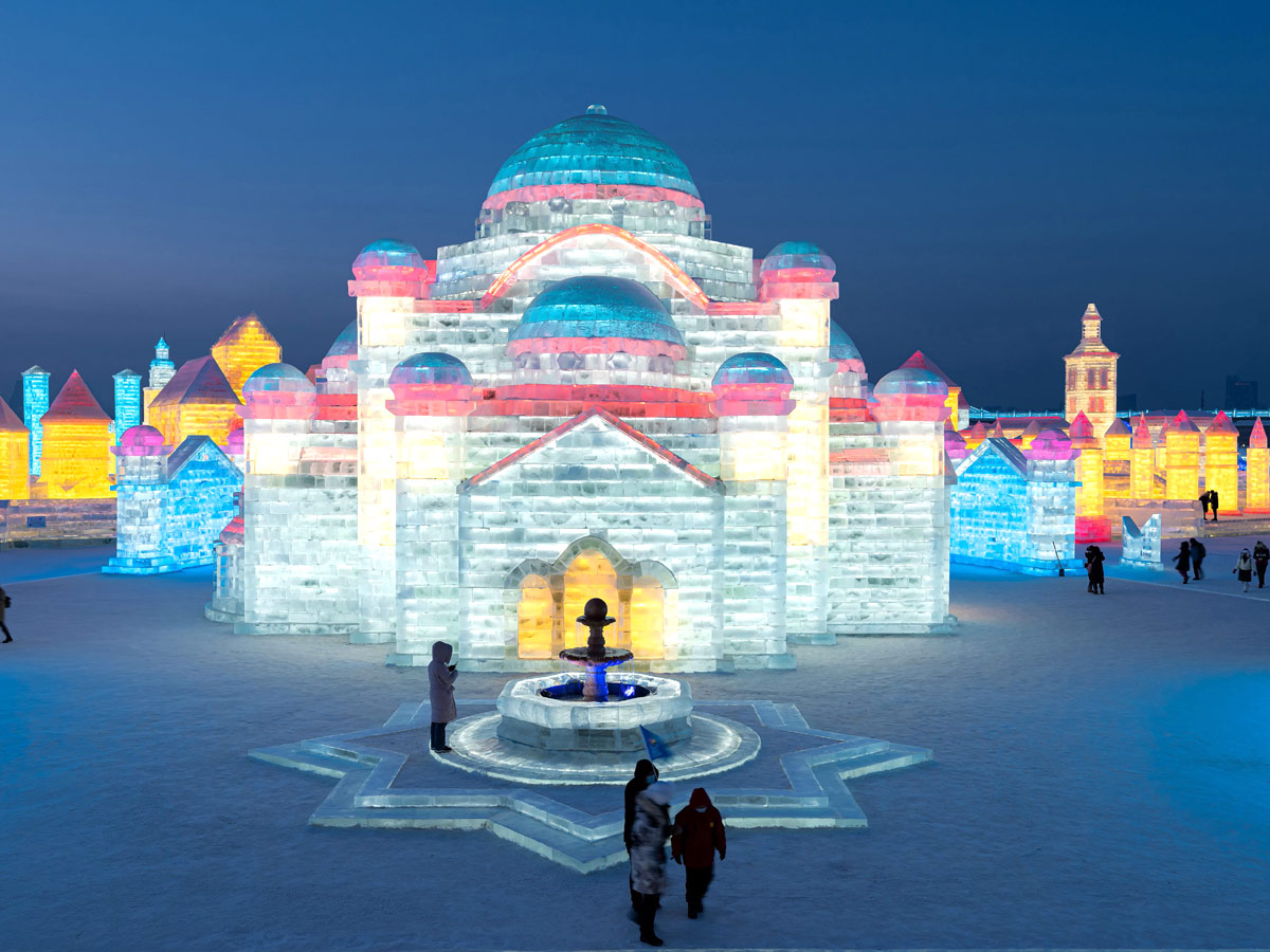 China: People take photos in front of ice sculptures at the Harbin Ice and Snow Festival - Sakshi2