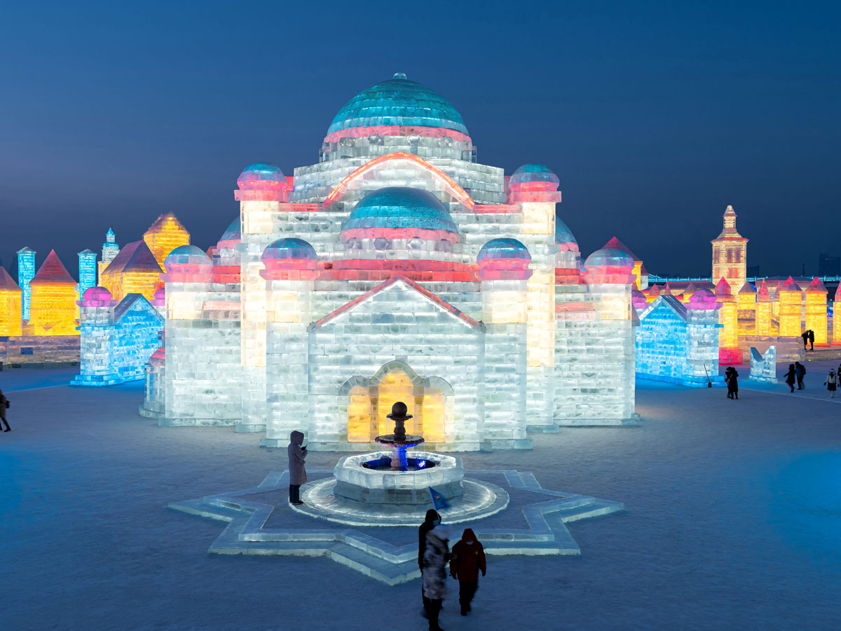 China: People take photos in front of ice sculptures at the Harbin Ice and Snow Festival - Sakshi4