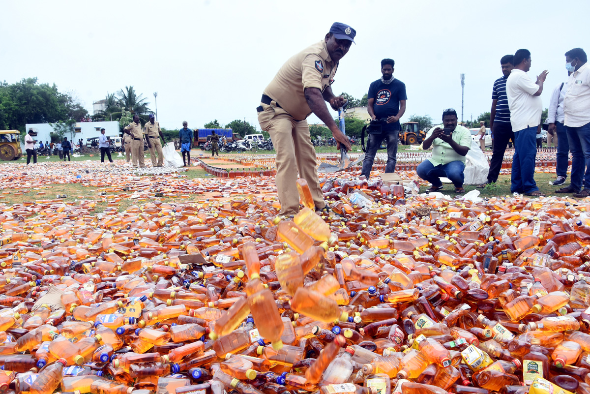 Liquor Bottles Crushed By Road Roller In Nellore - Sakshi7