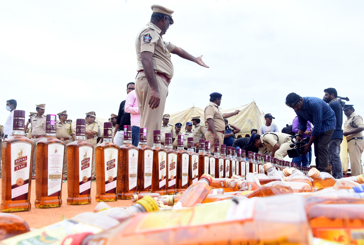 Liquor Bottles Crushed By Road Roller In Nellore - Sakshi13