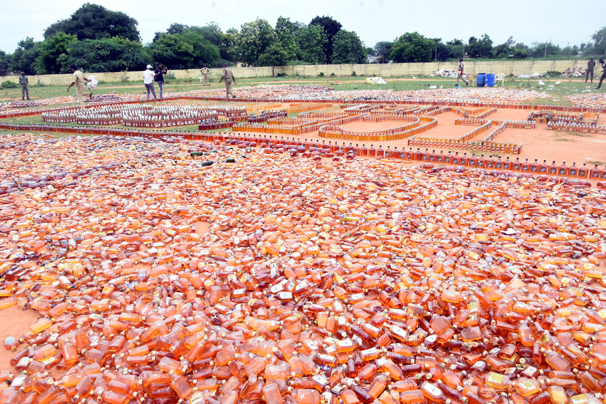 Liquor Bottles Crushed By Road Roller In Nellore - Sakshi15