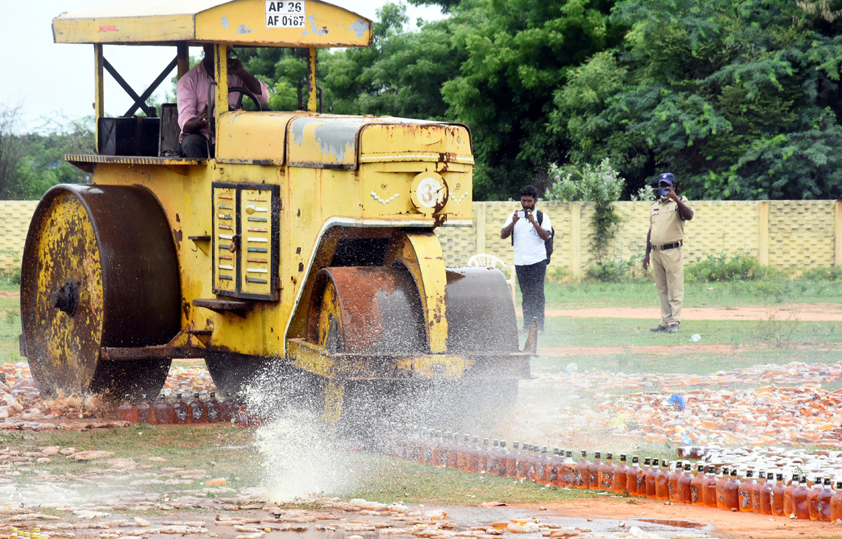 Liquor Bottles Crushed By Road Roller In Nellore - Sakshi18