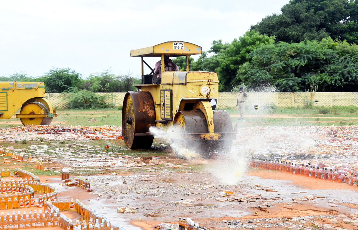 Liquor Bottles Crushed By Road Roller In Nellore - Sakshi19