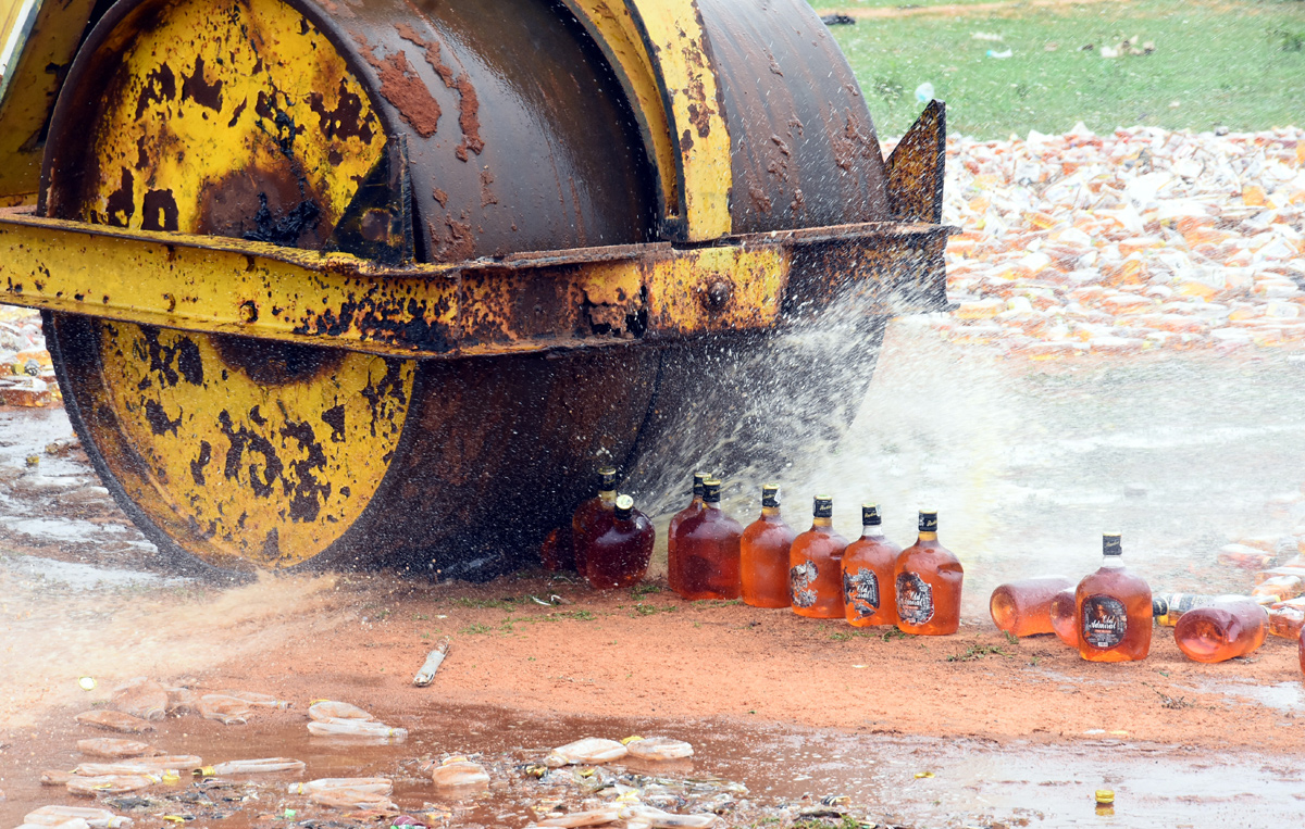 Liquor Bottles Crushed By Road Roller In Nellore - Sakshi21