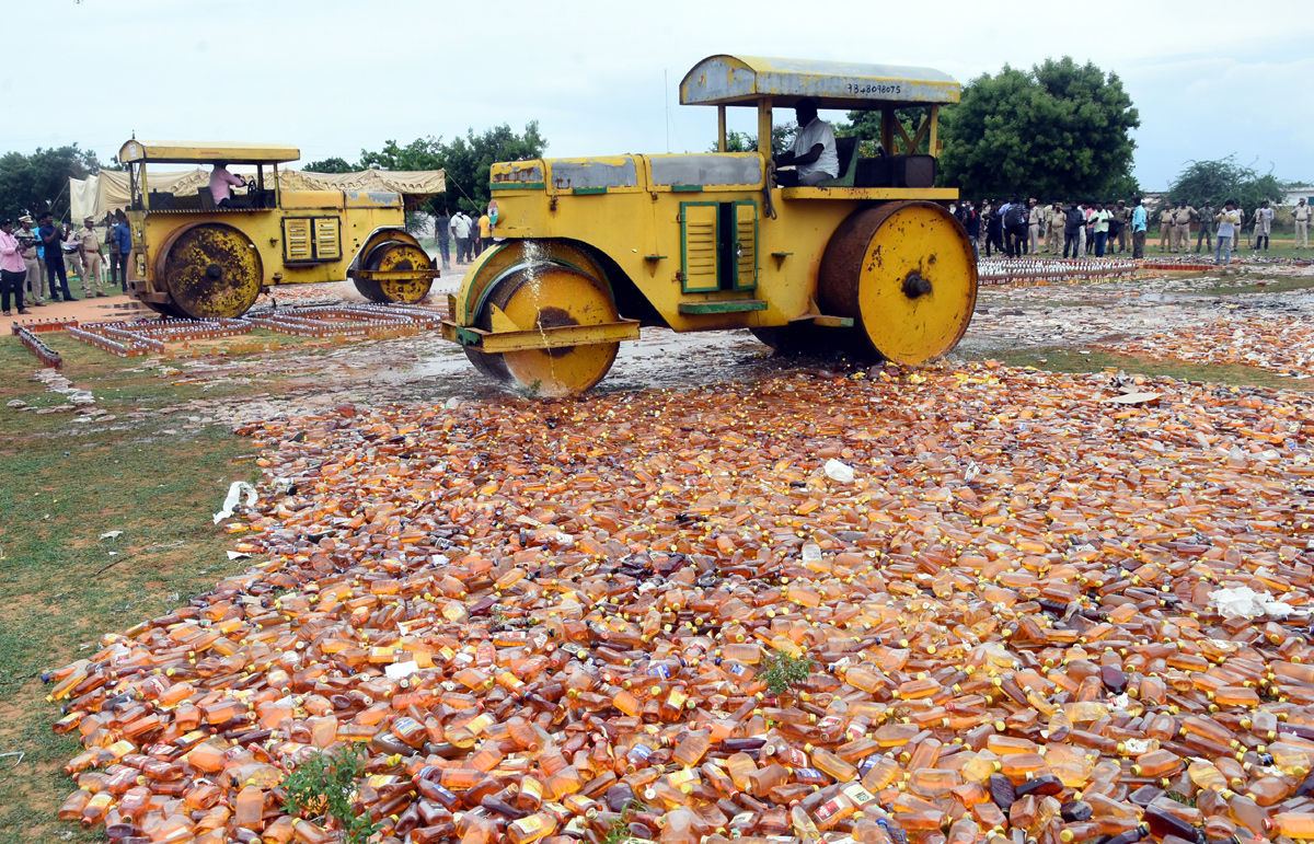 Liquor Bottles Crushed By Road Roller In Nellore - Sakshi24