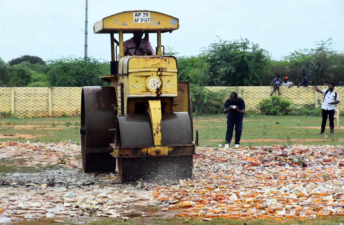 Liquor Bottles Crushed By Road Roller In Nellore - Sakshi25