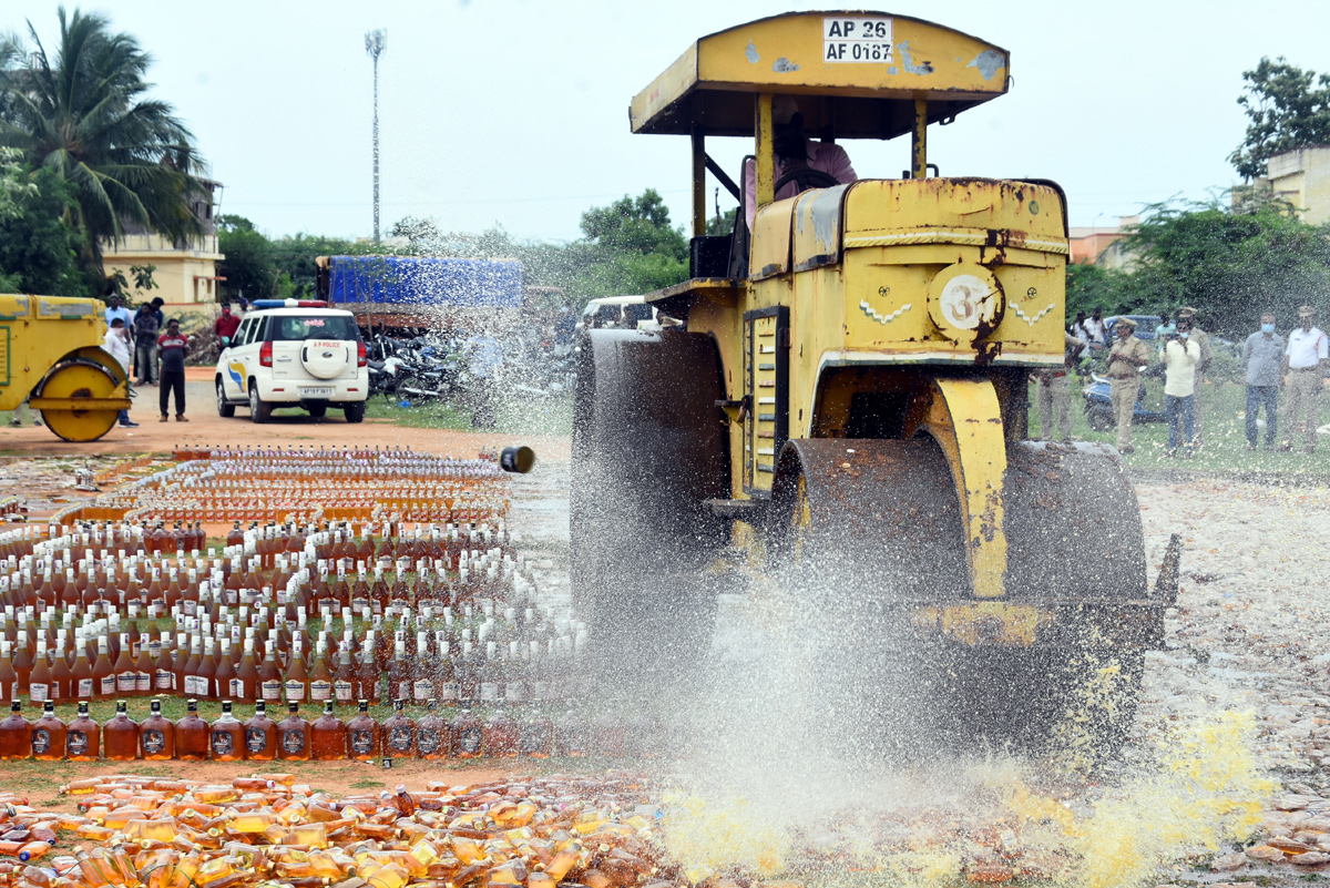 Liquor Bottles Crushed By Road Roller In Nellore - Sakshi26