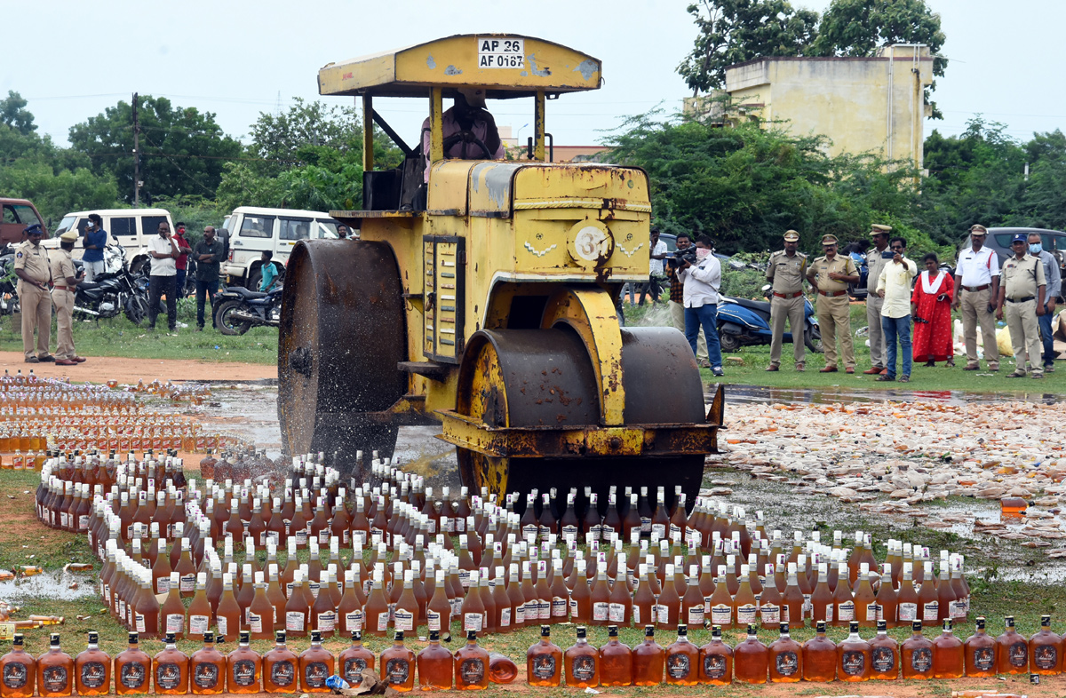 Liquor Bottles Crushed By Road Roller In Nellore - Sakshi1