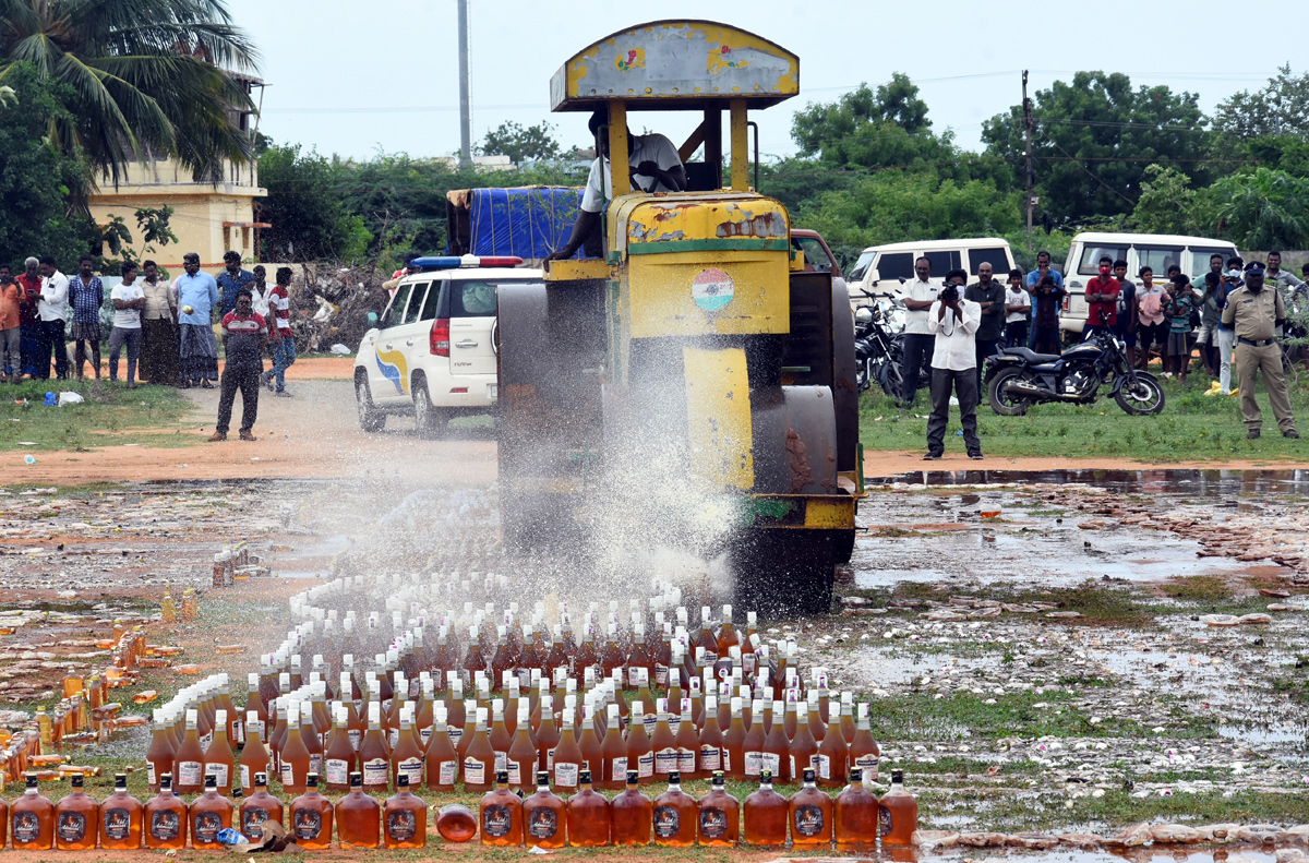 Liquor Bottles Crushed By Road Roller In Nellore - Sakshi27