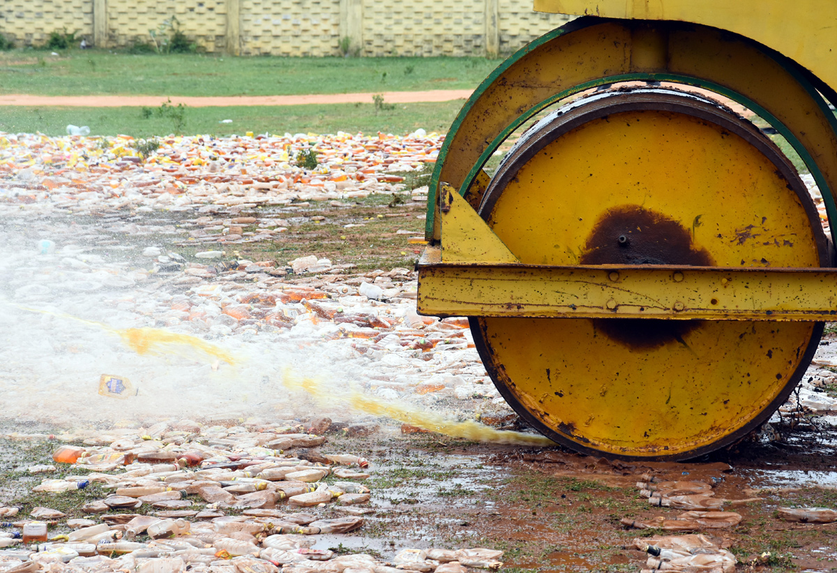 Liquor Bottles Crushed By Road Roller In Nellore - Sakshi30