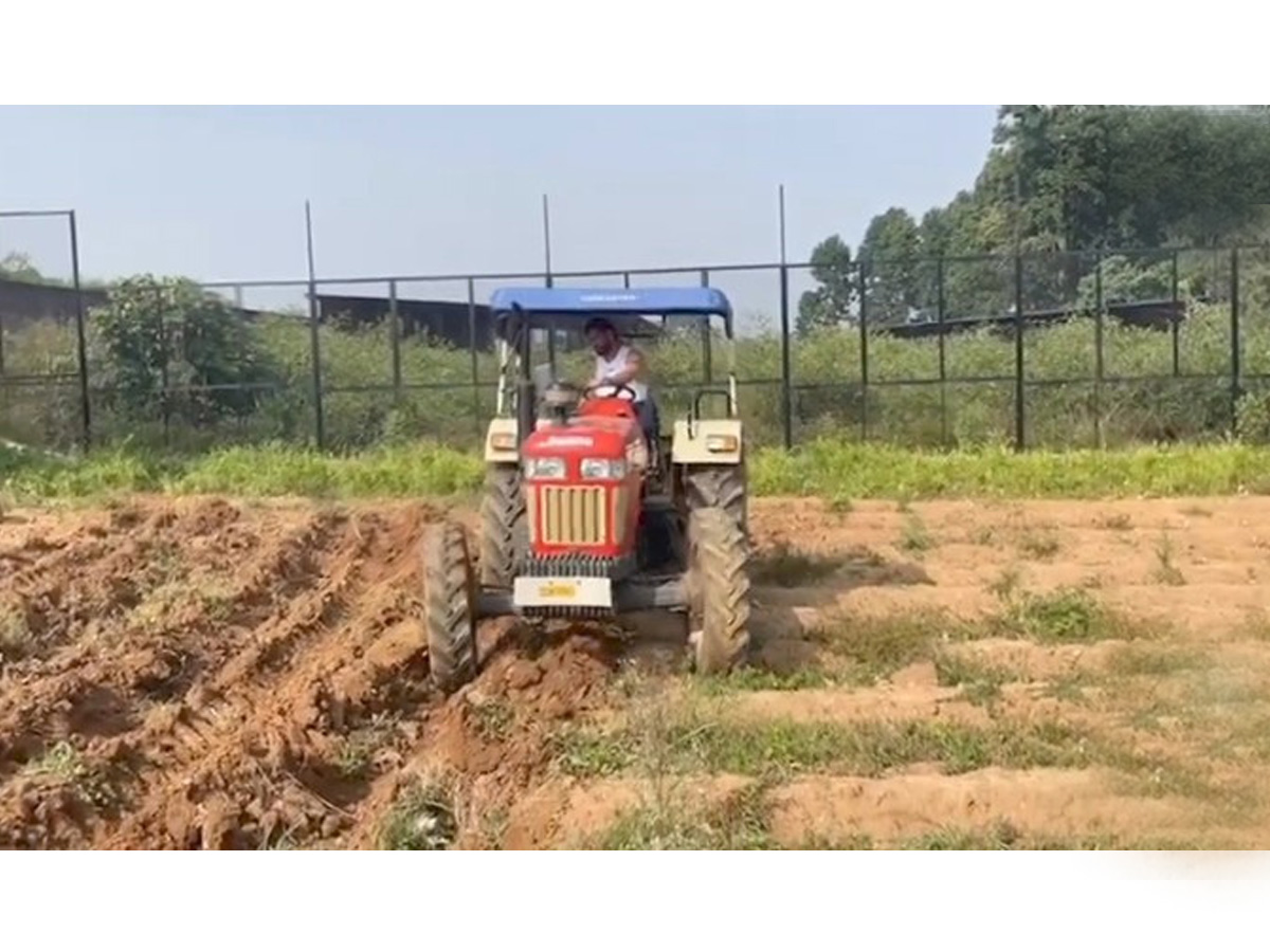 Dhoni Driving tractor while farming Photos - Sakshi5