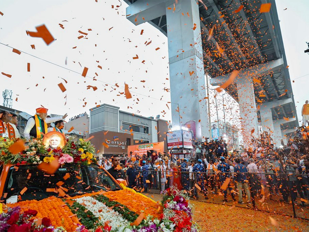 Narendra Modi greets supporters as he arrives for an election campaign rally - Sakshi9