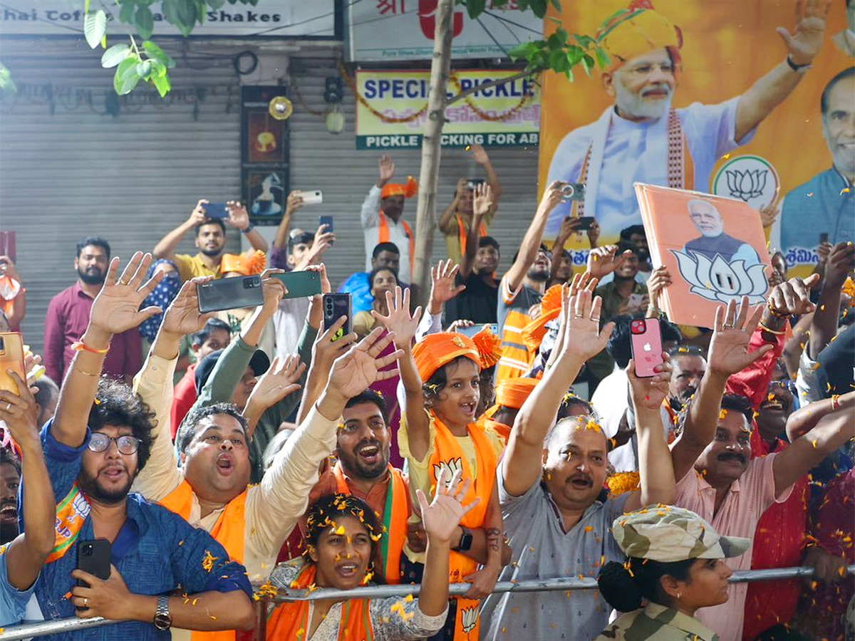 Narendra Modi greets supporters as he arrives for an election campaign rally - Sakshi10