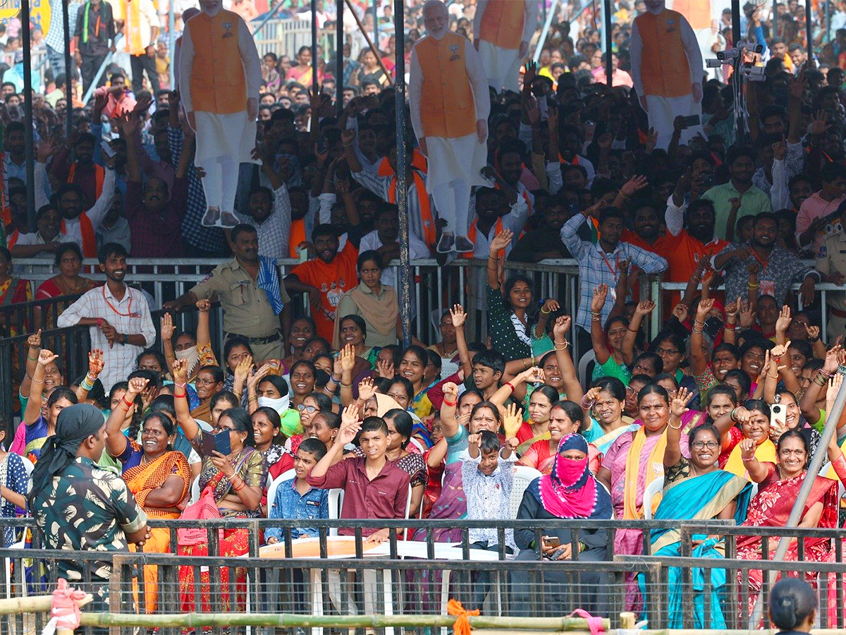 Narendra Modi greets supporters as he arrives for an election campaign rally - Sakshi12