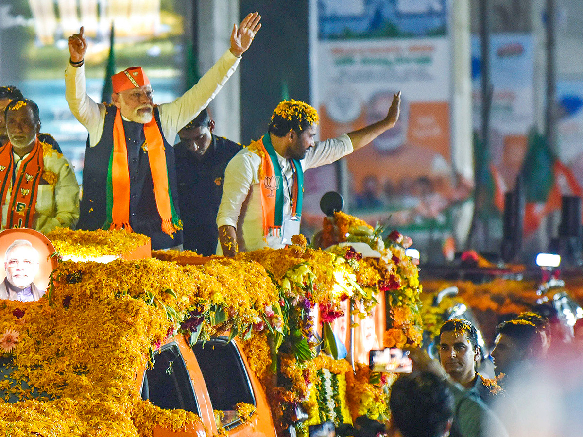 Narendra Modi greets supporters as he arrives for an election campaign rally - Sakshi16