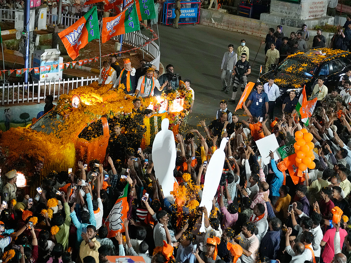 Narendra Modi greets supporters as he arrives for an election campaign rally - Sakshi19