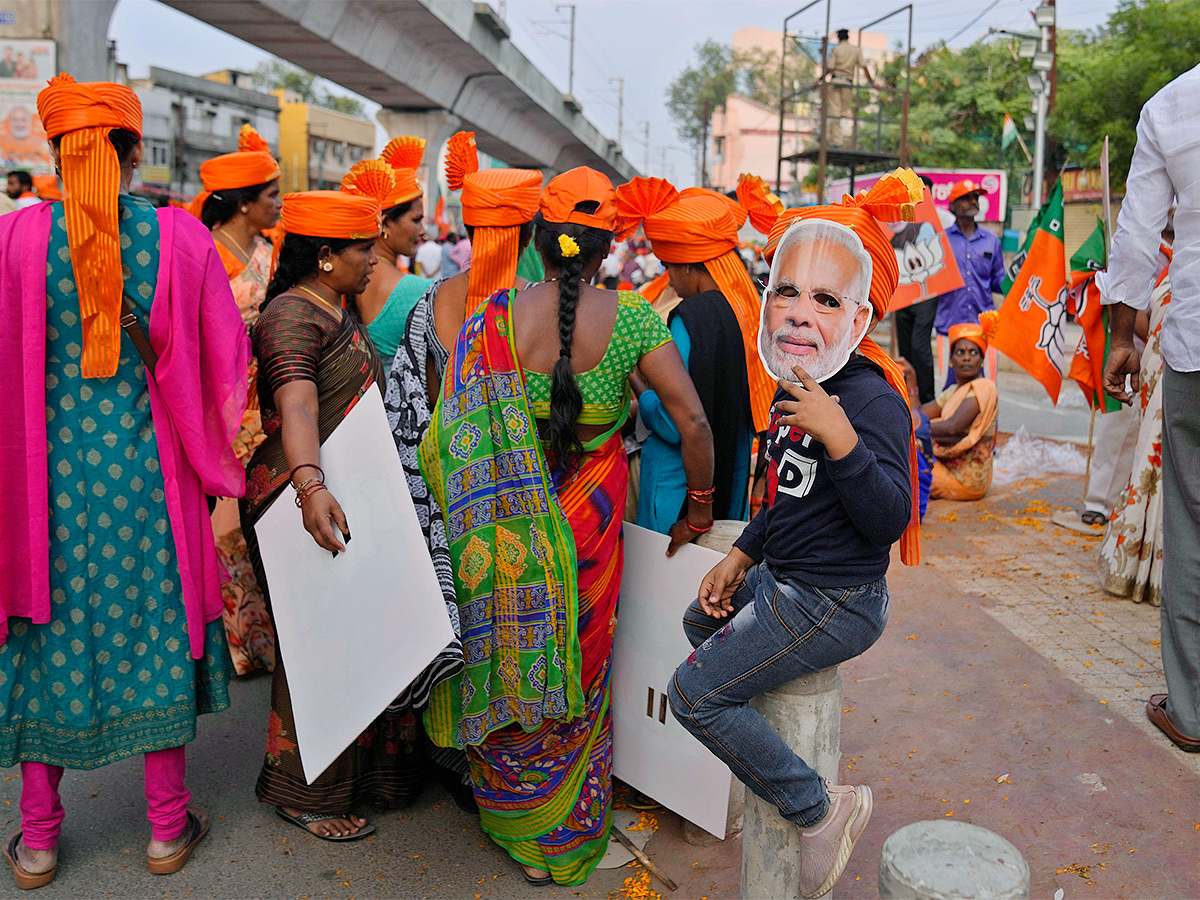 Narendra Modi greets supporters as he arrives for an election campaign rally - Sakshi20