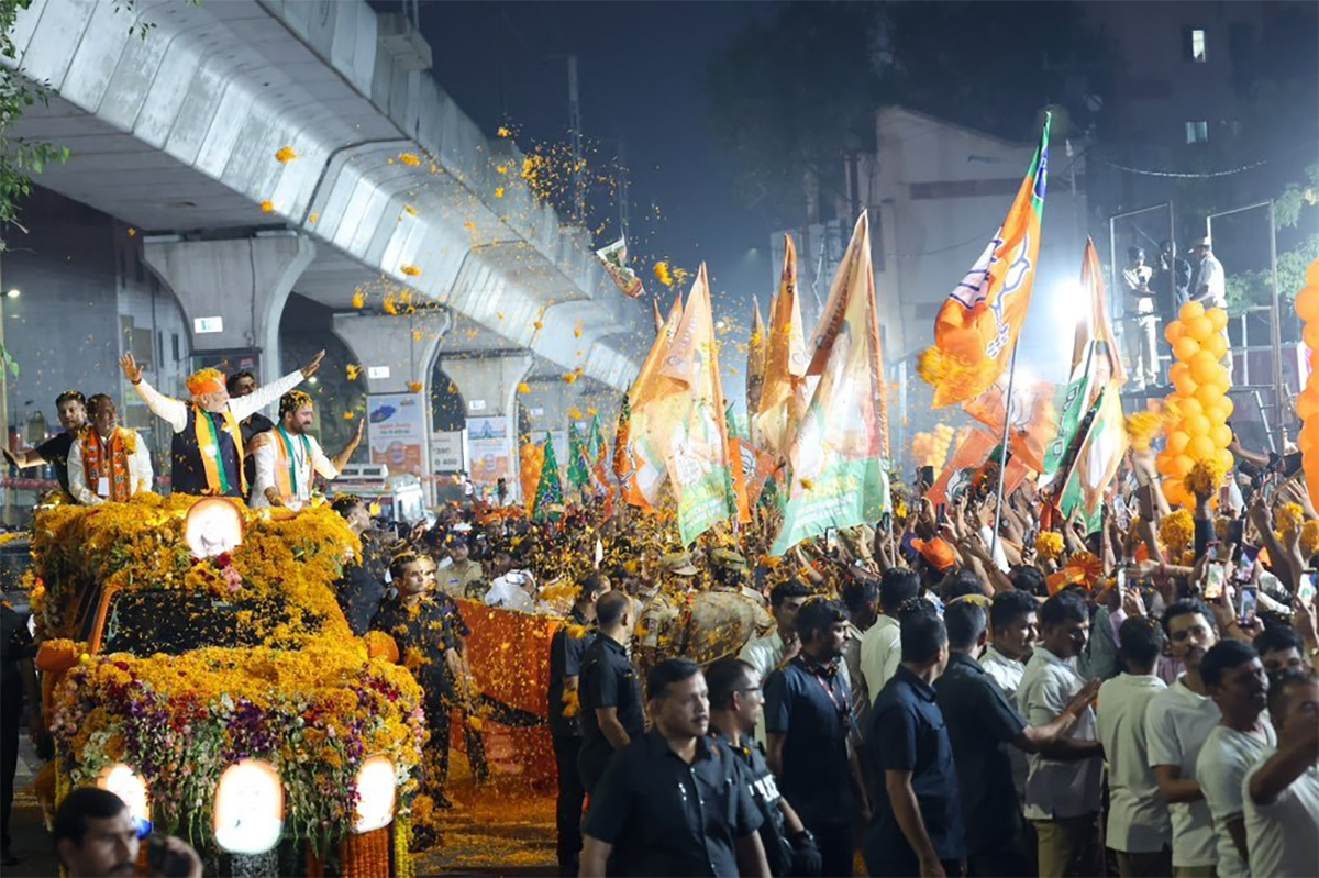 Narendra Modi greets supporters as he arrives for an election campaign rally - Sakshi3