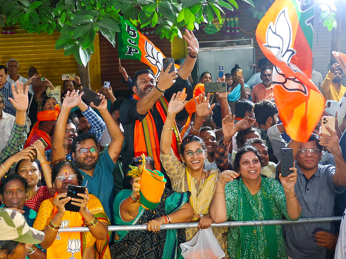 Narendra Modi greets supporters as he arrives for an election campaign rally - Sakshi4