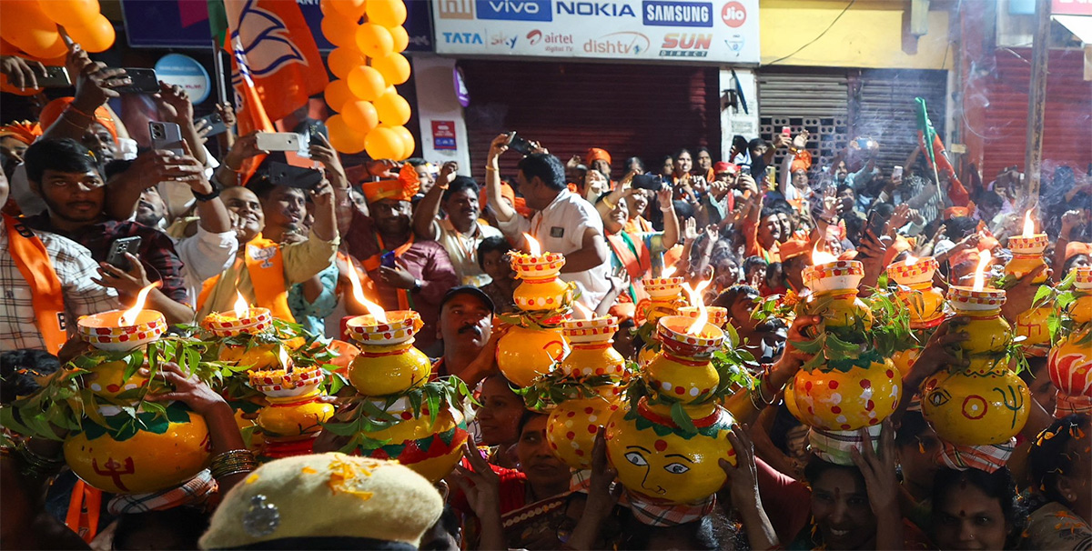 Narendra Modi greets supporters as he arrives for an election campaign rally - Sakshi5