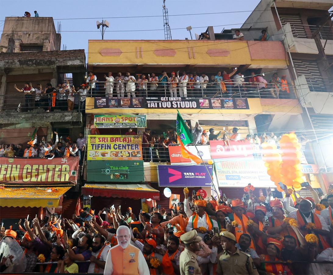 Narendra Modi greets supporters as he arrives for an election campaign rally - Sakshi6