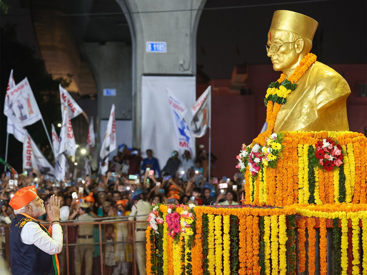 Narendra Modi greets supporters as he arrives for an election campaign rally - Sakshi7