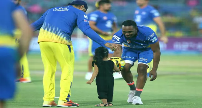 Bravo Dances With Dhoni Daughter For Champions Song - Sakshi