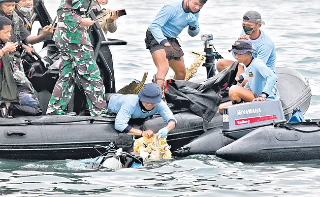 Indonesia locates black boxes of crashed jet as body parts recovered - Sakshi