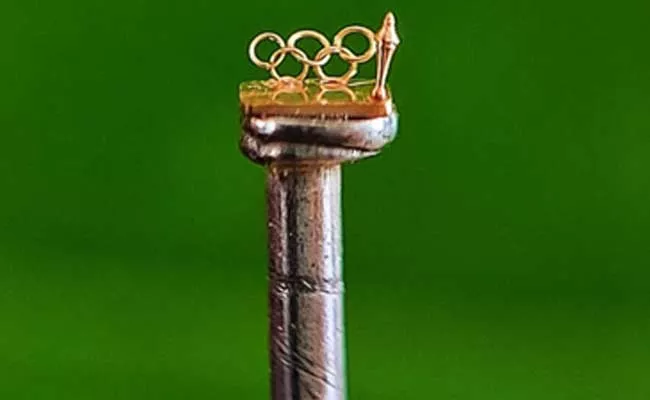Srisailapu Chinnaiah Chary Made Micro Gold Olympics Symbol On Pin - Sakshi