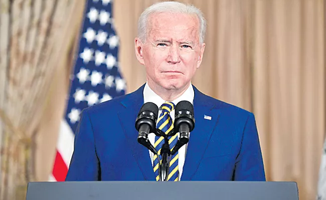 USA President Biden unveils sanctions on Russian banks - Sakshi